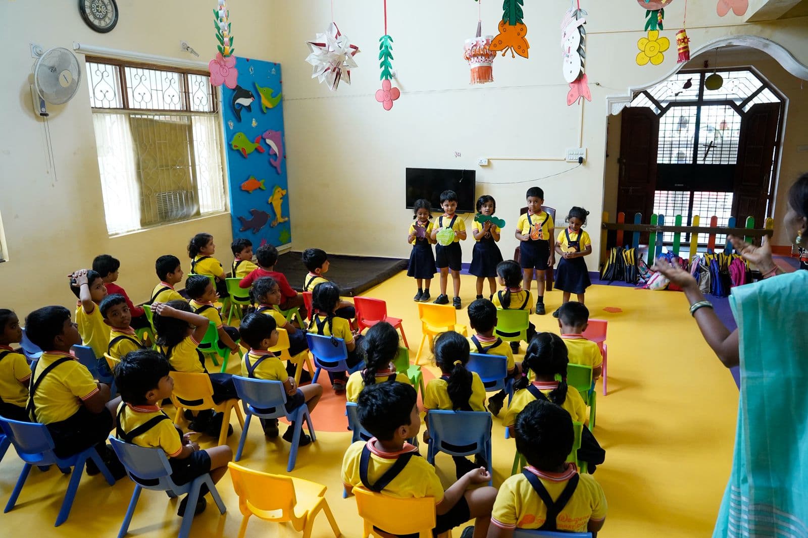 Children happily playing and learning in the classroom at Small Wonders